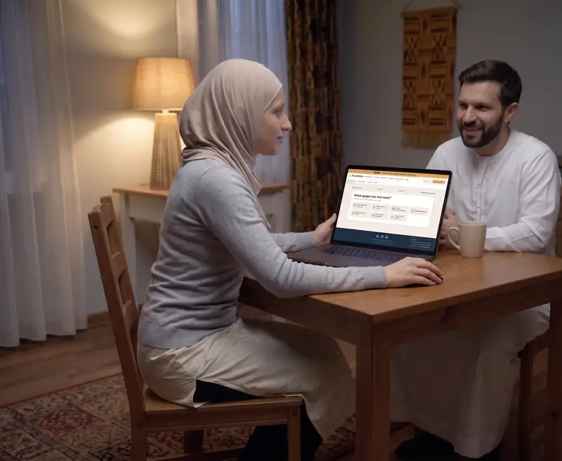 The same couple, calm, reading an explanation on a laptop